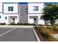 Modern townhome exterior with stone and white siding at 633 Trikomo Dr, Davenport, FL 33896