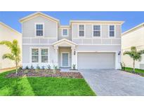 Two-story house with gray siding and landscaped yard at 4289 Lana Ave, Davenport, FL 33897