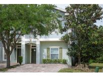 Two-story house with gray siding and green shutters at 2388 Caravelle Cir, Kissimmee, FL 34746