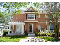 Townhouse with a charming front porch and well-manicured landscaping at 2208 San Vittorino Cir # 101, Kissimmee, FL 34741