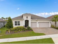 A beautiful house exterior with three-car garage and landscaping at 2282 Kaley Ridge Rd, Clermont, FL 34715