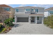 Two story home with stone accents and a large driveway at 300 Falls Dr, Kissimmee, FL 34747