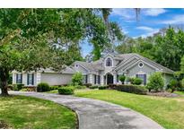 Two-story home with a circular driveway and landscaping at 310 Vista Oak Dr, Longwood, FL 32779