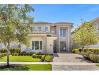 Two-story house with stone accents and a landscaped front yard at 967 Jack Nicklaus Ct, Kissimmee, FL 34747