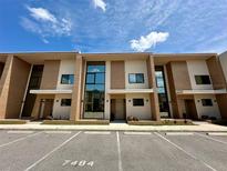 Modern townhouses with parking and neutral color scheme at 7484 Brooklyn Dr, Kissimmee, FL 34747
