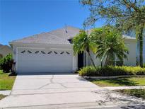 Single-story home with a two-car garage and landscaped yard at 13620 Waterhouse Way, Orlando, FL 32828