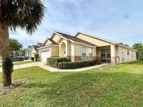 Single-story house with a two-car garage and well-manicured lawn at 2555 Oneida Loop, Kissimmee, FL 34747