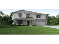 Two story house with a two car garage and manicured lawn at 2223 Elegant Manor Cir, Edgewater, FL 32141
