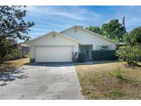 One-story house with attached garage and landscaped front yard at 221 Rosa Ave, Oviedo, FL 32765