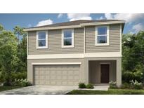 Two-story house with neutral exterior and attached garage at 257 Acorn Rd, Haines City, FL 33844