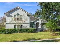 Two-story house with gray siding, landscaping, and a spacious lawn at 858 Creston Dr, Maitland, FL 32751