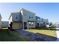 Modern two-story home with yellow garage door at 4326 Scene Ln, Kissimmee, FL 34746