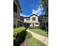 Two-story home with a charming facade and landscaped yard at 992 Tillery Way # 103, Orlando, FL 32828