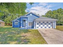 Charming blue house with a two-car garage at 1112 Royal Marquis Cir, Ocoee, FL 34761
