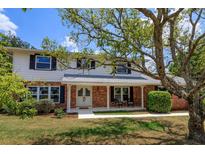 Two-story house with brick and white siding, updated windows, and a spacious lawn at 965 Tuskawilla Rd, Winter Springs, FL 32708