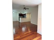 Open living space with hardwood floors and kitchen view at 5132 Conroy Rd # 937, Orlando, FL 32811