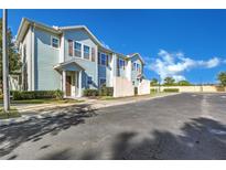 Two-story home with light blue siding and brown accents at 8986 Silver Pl, Kissimmee, FL 34747