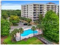Community pool with surrounding landscaping at 6312 Buford St # 303, Orlando, FL 32835