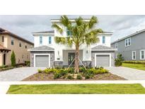 Two-story home with gray stone accents and landscaping at 1136 Castle Pines Ct, Reunion, FL 34747