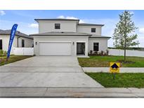 Two-story house with a two-car garage and modern facade at 6398 Chorus Dr, Mascotte, FL 34753