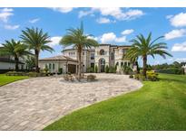 Two-story luxury home with palm trees and a large driveway at 4029 Isabella Cir, Windermere, FL 34786