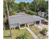 Single story home with gray roof, covered porch, and walkway at 111 10Th St, New Smyrna Beach, FL 32168