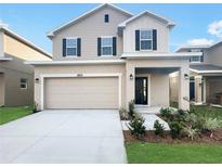 Two-story house with neutral siding and two-car garage at 3672 Sagefield Dr, St Cloud, FL 34773