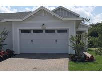Two-car garage with a brick paved driveway at 2333 Datura Loop, St Cloud, FL 34772