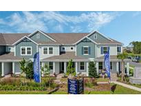 Two-story townhouse with a gray exterior and landscaping at 14034 Scarlet Aster Aly, Winter Garden, FL 34787