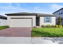 Charming one-story home with a two-car garage and well-manicured lawn at 2466 Leeds St, Haines City, FL 33844