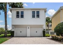 Two-car garage with light beige doors at 7576 Excitement Dr, Reunion, FL 34747