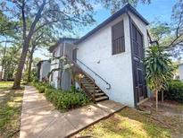 Two-story condo with a staircase and lush landscaping at 196 Riverbend Dr # 204, Altamonte Springs, FL 32714