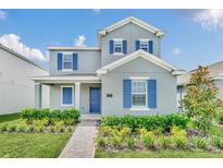 Two-story home with blue shutters and landscaped front yard at 5115 Lake Hamlin Trl, Winter Garden, FL 34787