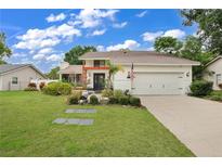 Charming two-story home with landscaped yard and attached two-car garage at 603 Antilla Ave, Altamonte Springs, FL 32714