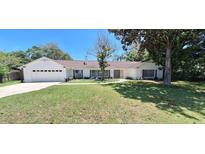 Newly renovated home with a white exterior and landscaping at 1030 Gregory Dr, Maitland, FL 32751