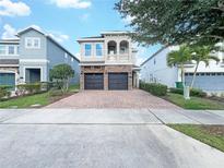 Two-story house with a two-car garage and well-manicured lawn at 7574 Marker Ave, Kissimmee, FL 34747