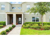 Modern townhome exterior with landscaped front at 404 Ocean Course Ave, Davenport, FL 33896