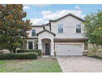 Two story house with stone accents and landscaping at 1431 Wexford Way, Davenport, FL 33896