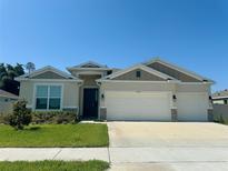 Two-story house with a three-car garage and landscaped lawn at 17926 Hither Hills Cir, Winter Garden, FL 34787