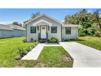 Newly built home with gray siding, landscaping, and concrete driveway at 702 S Myrtle Ave, New Smyrna Beach, FL 32168