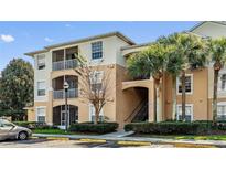 Condo building with palm trees and parking at 6214 Stevenson Dr # 201, Orlando, FL 32835