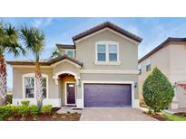 Two-story house with a two-car garage and palm trees at 1586 Lima Ave, Kissimmee, FL 34747