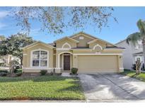 Tan house with 2-car garage, great curb appeal at 2524 Dover Glen Cir, Orlando, FL 32828
