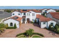Two-story home with tile roof, solar panels and brick driveway at 15680 Panther Lake Dr, Winter Garden, FL 34787
