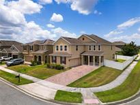 Two-story house with a brick driveway and manicured lawn at 1508 Caterpillar St, St Cloud, FL 34771