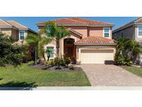 Two story home with tile roof and landscaping at 2588 Shanti Dr, Kissimmee, FL 34746