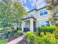 Modern townhouse with landscaped front yard and porch at 14971 Apollo Bond Dr, Winter Garden, FL 34787