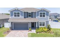 Two story home with gray siding, two car garage and landscaping at 7904 Waterfield Ave # 1, Orlando, FL 32832