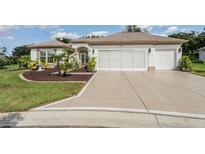 House exterior with landscaping and a two car garage at 12857 Se 92Nd Court Rd, Summerfield, FL 34491