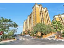 Resort style building with ample parking and lush landscaping at 8125 Resort Village Dr # 5509, Orlando, FL 32821